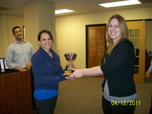 AHP Employee Denisse Bays receives her trophy